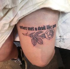 a woman's leg with a tattoo saying, where met a devil like you