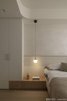 a bedroom with a bed, nightstand and lamp in the corner on the wall next to it