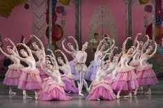 dancers in pink and white tutu skirts on stage