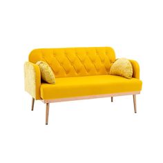 a yellow couch sitting on top of a white floor next to a wooden frame and pillow