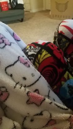 a child wrapped in a hello kitty blanket