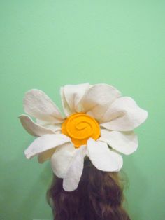 a woman's head with a paper flower on it