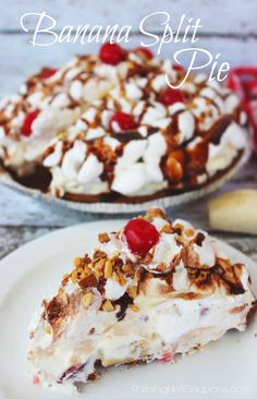 a piece of pie on a white plate topped with whipped cream, nuts and a cherry