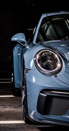 the front end of a blue sports car