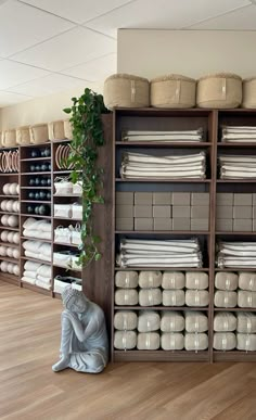 a room filled with lots of different types of cloths and baskets on top of shelves