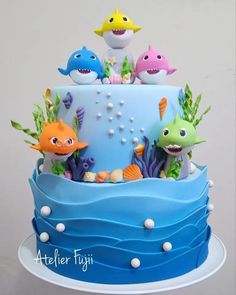 there is a blue cake decorated with sea animals and fish on it's sides