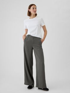 Soft woven trousers.  E-waist with concealed hook and bar closure, zip fly.  Front slant pockets, back welt pockets.  Flat front.  * Fit: Classic.  An easy silhouette that fits close  at the waist, and is relaxed through the hips and thigh.  Models wearing Gap Women’s Work Trousers, High Rise Trousers, Capsule Wardrobe Basics, Easy Silhouette, Red Trousers, Work Trousers, Wardrobe Basics, Grey Pants, Work Pants