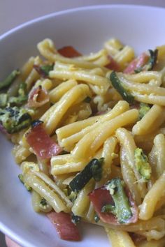 a white bowl filled with pasta and vegetables