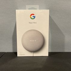 the google home mini is in its box and it's still in its packaging