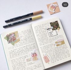 an open notebook with some stickers and pens on top of it next to a pencil