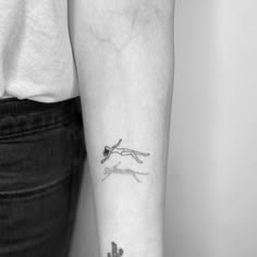 a woman's arm with a tattoo on it that has a small cactus in the middle