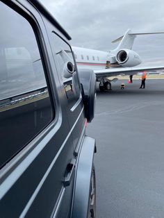 an airplane that is sitting on the tarmac next to a truck with it's door open