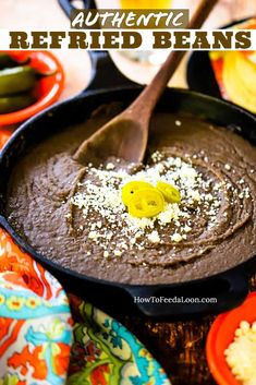 a pan filled with chocolate pudding and topped with white flecks, on top of colorful plates