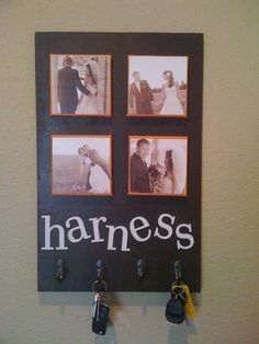 a black and white photo hanging on a wall with four key hooks attached to it