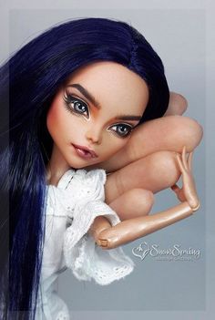 a doll with blue hair is posed for a photo