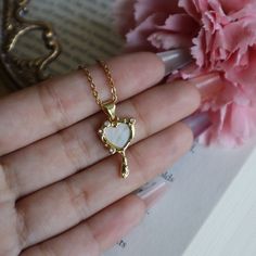 Magic Mirror Necklace, Heart Mirror Jewelry, Fairytale Necklace, Coquette Aesthetic, Gift for Her, Magical Jewelry, Cute Girly Necklace ☽ 14K Gold Plated, Cubic Zirconia, Shell Pendant (25.7x12.5mm) ☽ This is a gold plated charm meaning that it requires extra care to keep its shine and color intact. Please follow these tips to make the charm last longer in its original condition: avoid wearing it to the beach, pool, shower, bathtub, hot tub; avoid it touching any lotions, creams, or sweat; take Mirror Pendant Necklace, Fairycore Jewelry As A Gift, Fairycore Clavicle Chain Jewelry As Gift, Fairycore Clavicle Chain Necklace As Gift, Fairycore Clavicle Necklace As A Gift, Fairycore Style Clavicle Chain Jewelry As A Gift, Dainty Heart Necklace With Clavicle Chain For Jewelry Making, Fairycore Heart-shaped Jewelry Gift, Fairycore Heart-shaped Gift Jewelry