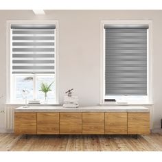 two windows with blinds in the middle of them, and a counter top on one side