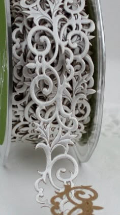 a spool of white thread with intricate designs on it