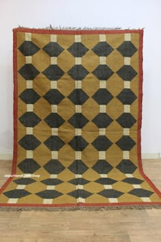 an old rug is displayed on the floor