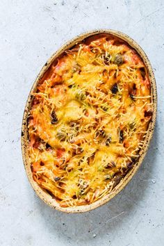 an overhead view of a casserole dish with cheese and vegetables