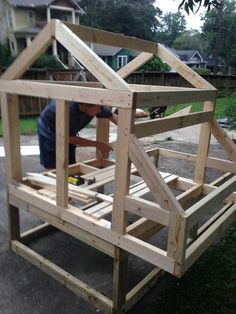 a man is building a house out of wood