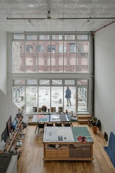 an empty room with lots of windows and furniture on the floor in front of it