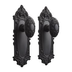 two antique style door knobs with ornate designs