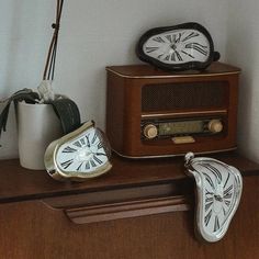 an old fashioned radio sitting on top of a wooden shelf next to a pair of shoes