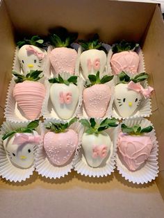 a box filled with chocolate covered strawberries and hello kitty decorations on top of each other