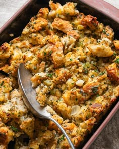 a spoon in a casserole dish with stuffing