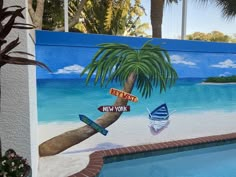 a painting on the side of a building with a palm tree next to a swimming pool