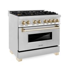 a white and gold stove with four burners