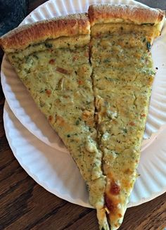 two slices of cheese pizza on paper plates