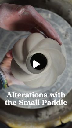 a person is working on a vase with the words, alterations with the small paddle