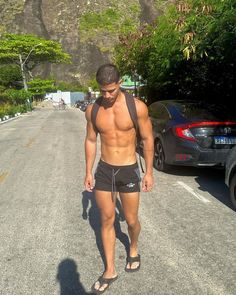 a shirtless man walking down the street