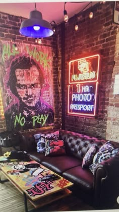 a living room with couches, tables and neon signs on the wall behind them