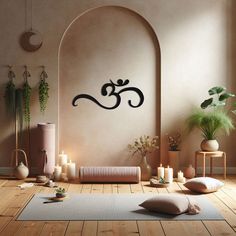 a yoga room with candles, rugs and wall art on the walls in black