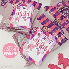 valentine's day candy bags with pink and purple decorations on them, including cookies