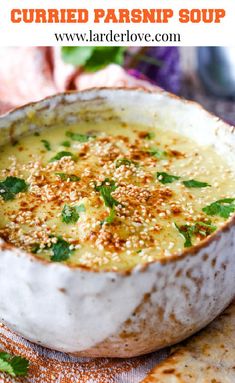 a bowl of baked parsnip soup on a plate with pita bread