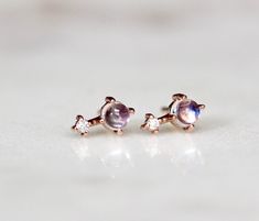 "These earrings are the sweetest! Handcrafted from 14K gold and featuring a moonstone accented by a tiny diamond, our \"Love Drop\" earrings are gorgeous on their own or paired with matching necklace! - 3mm smooth moonstone - Diamond measures 1.3 mm (.01 Ct each) - Available in 14K rose, yellow or white gold - Comes with matching butterfly backings Link to matching necklace here: https://www.etsy.com/listing/511146795/14k-moonstone-diamond-necklace-love-drop?ref=shop_home_active_14 For our ameth Astrology Jewelry, Tiny Diamond, June Birthstone, Stone Studs, Rose Yellow, June Birth Stone, Matching Necklaces, Drop Necklace, Dainty Jewelry