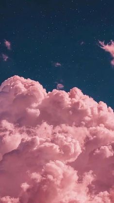 the sky is filled with pink clouds and stars