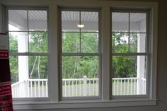 two windows in a room with white trim