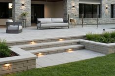 an outdoor living area with steps lit up