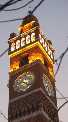 a large clock tower lit up at night