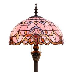 a lamp that is sitting on top of a table with a glass shade over it