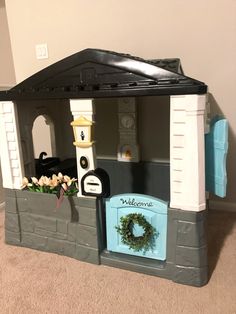 a toy house with a wreath on the door