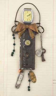 a clock that is attached to a wall with keys and other things hanging on it