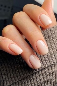 a woman's hand with almond colored nails