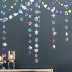 a room with some lights hanging from it's ceiling and decorations on the wall