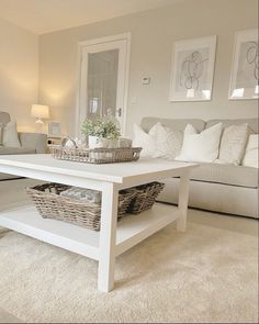 a white coffee table with baskets on it